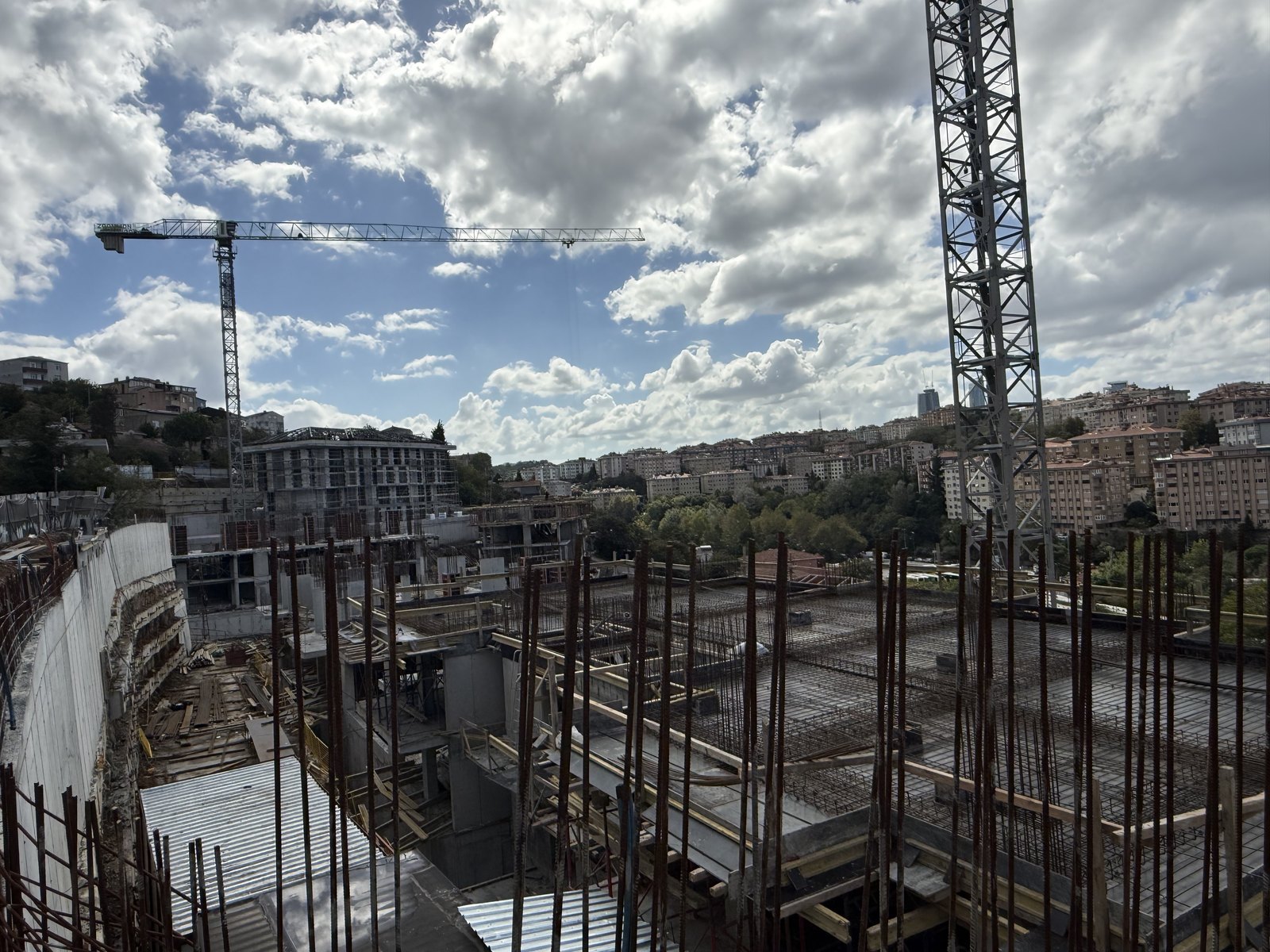 Steel frame and cranes on a plot under construction. October 2026